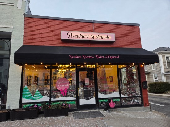 Goodness Gracious Kitchen & Cupboard, red brick building with black and pink signage.