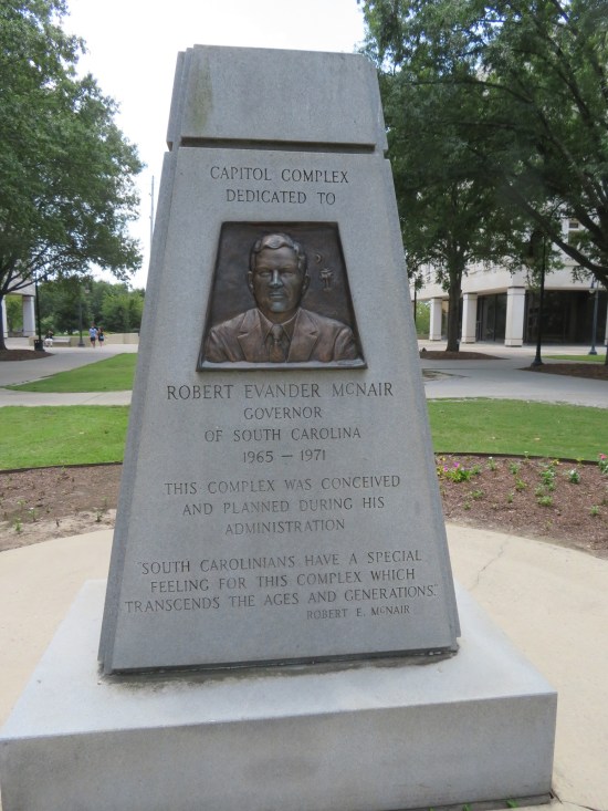 Governor Robert McNair trapezoidal monument with his face and much text. 