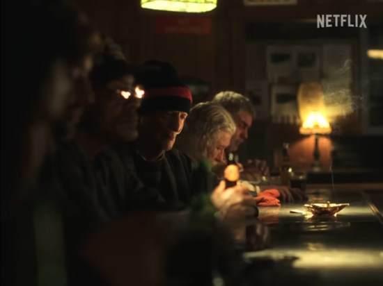 Bunch of old guys sitting in a smoky bar.