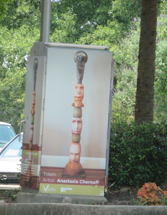 lightbox covered with photo of street meter converted into a tiny totem pole.