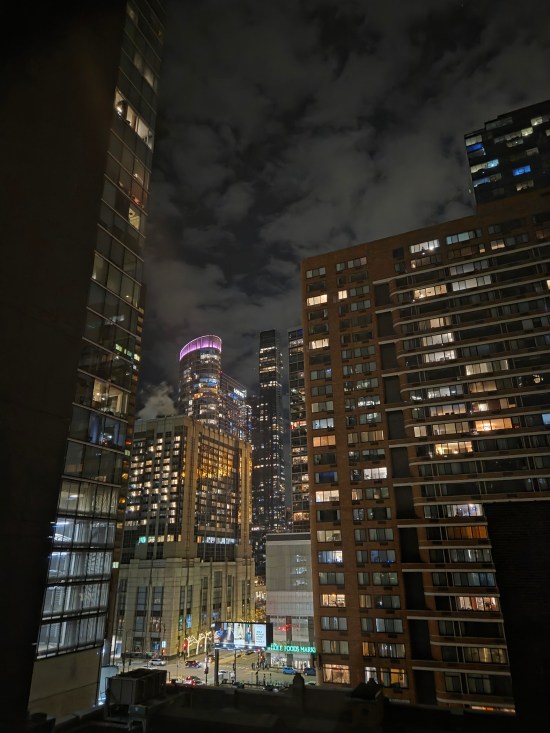 Nighttime view of multiple Chicago skyscrapers lit up.