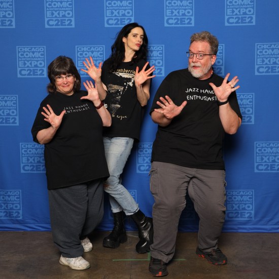 Us doing jazz hands with Krysten Ritter, who's wearing a Cranberries T-shirt, jeans, and black platform boots.