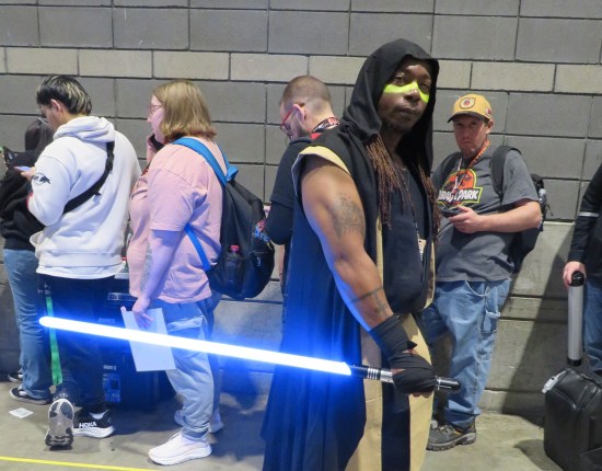 cosplay: Quinlan Vos from Star Wars with blue lightsaber.
