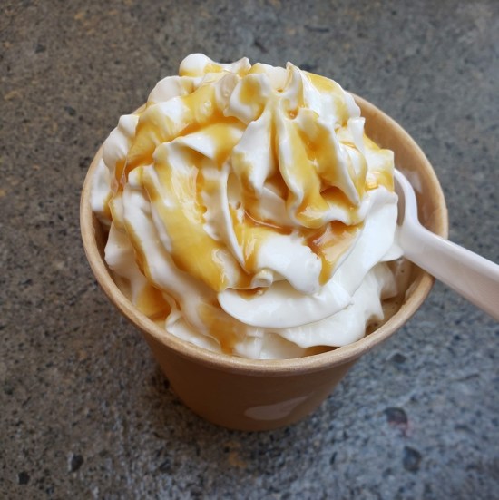 Coffee drink topped with whipped cream and drizzled caramel.
