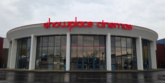 Showplace Cinemas Evansville, white circular building tall enough for its one IMAX screen, white pillars with red logo.