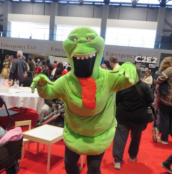 cosplay: Slimer coming at you at an angle, on red carpet.