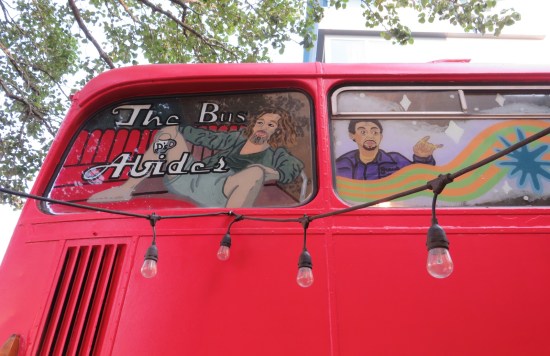 Double-decker bus upper front windows painted with pics of Jeff Bridges and John Turturro in character.