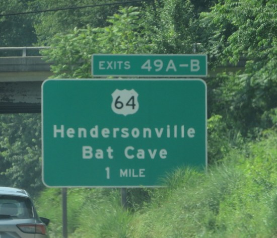 Interstate sign for Exits 49A and 49B to Hendersonville and Bat Cave and Highway 64, one mile ahead.