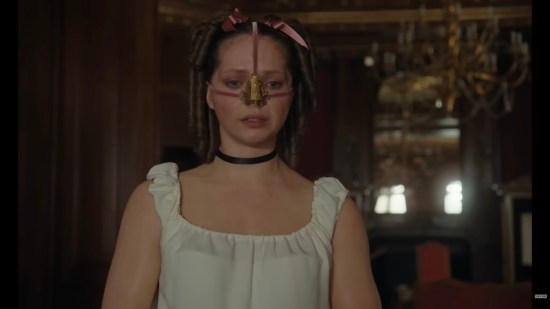 Victorian young lady in slip with Goldilocks hair and a medical lbrace strapped around her nose.