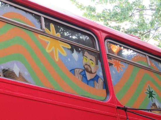 Double-decker upper window painted with pic of John Goodman.