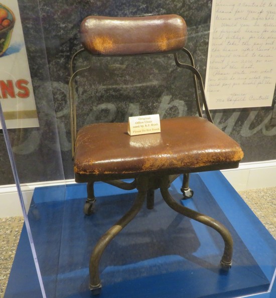 Old brown office chair in a glass case.