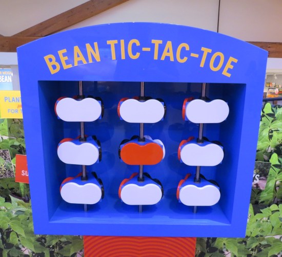 Large plastic tic-tac-toe board but with red and white beans instead of X's and O's.