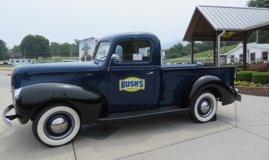 vintage blue pickup truck with the Bush's logo on the driver's door. Parked on the sidewalk in front of the visitor center.