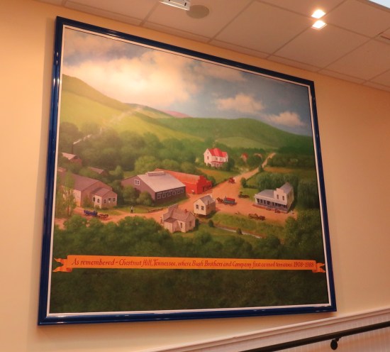 Painting of a small town labeled "As remembered, Chestnut Hill Tennessee, where Bush Brothers and Company first canned tomatoes 1908-1988".