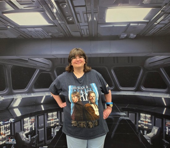 Anne standing in front of banner art depicting a Star Destroyer's main bridge.