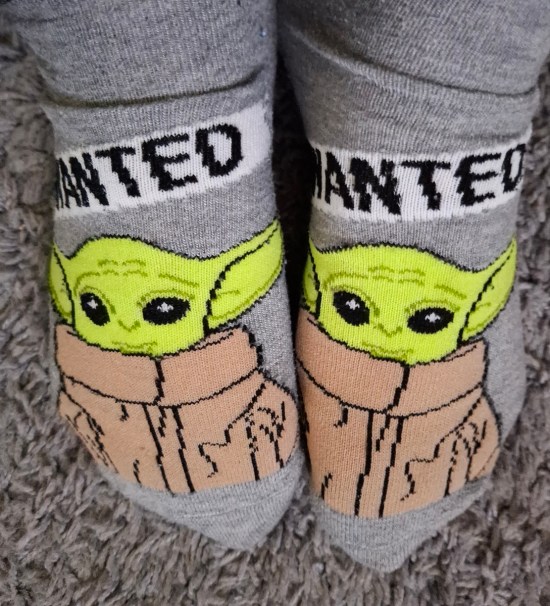 Gray women's socks, each with pics of Grogu labeled "WANTED".