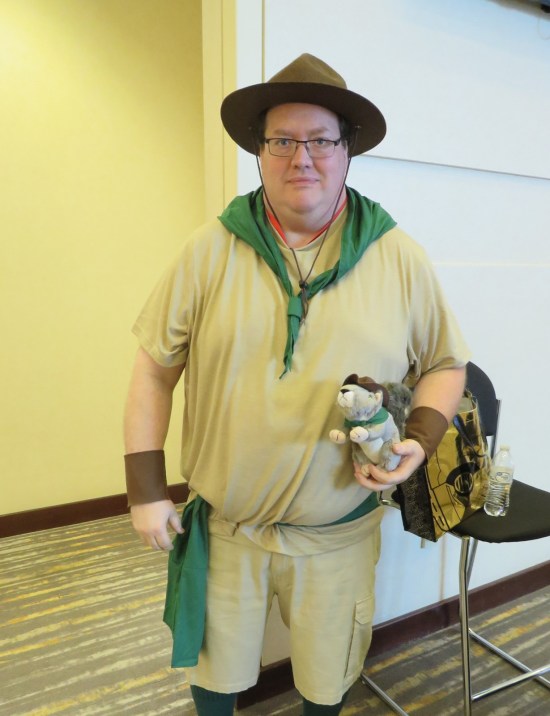 Camp Counselor Kronk in scout uniform with hat and green bandannas.