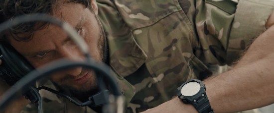 Military man Aaron Taylor-Johnson lies on ground, stares at two snaking black wires.
