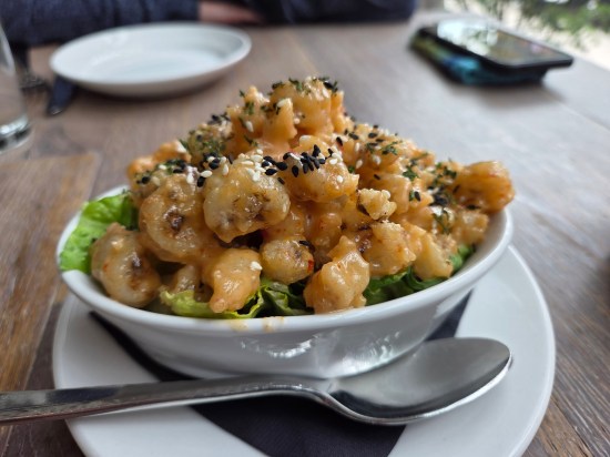 Kung Pao Rock Shrimp served atop lettuce.