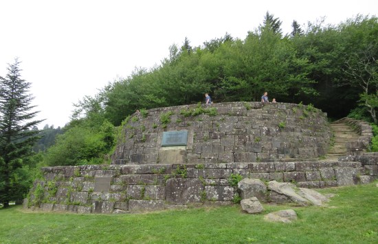 A stone fortress shaped like the blast shield bases on Endor. Metal plaque in the center.
