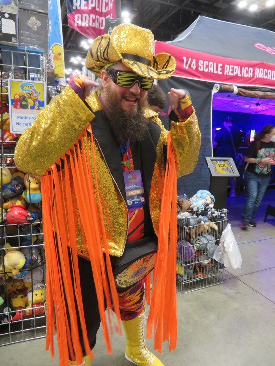 Macho Man Randy Savage costume with yellow cowboy hat and orange finery.