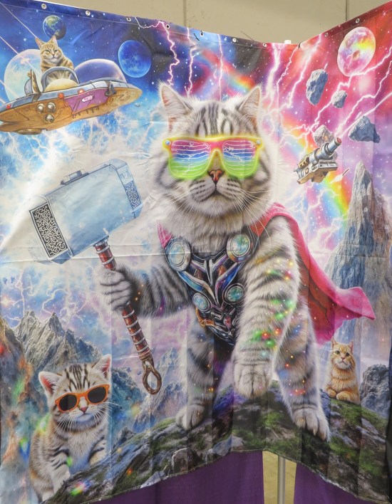 Poster of cat as Marvel's Thor but wearing sunglasses. He's surrounded by three other distant cats and space-themed backdrops and magic lightning.