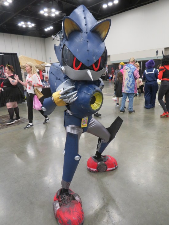 Blue mech costume shaped like a certain speedy blue hedgehog, but with chest cannon.