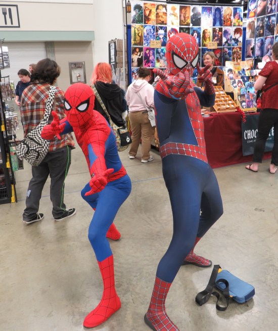 Two Spider-Man costumes, one from the 2002 movie and one traditional Spidey look.