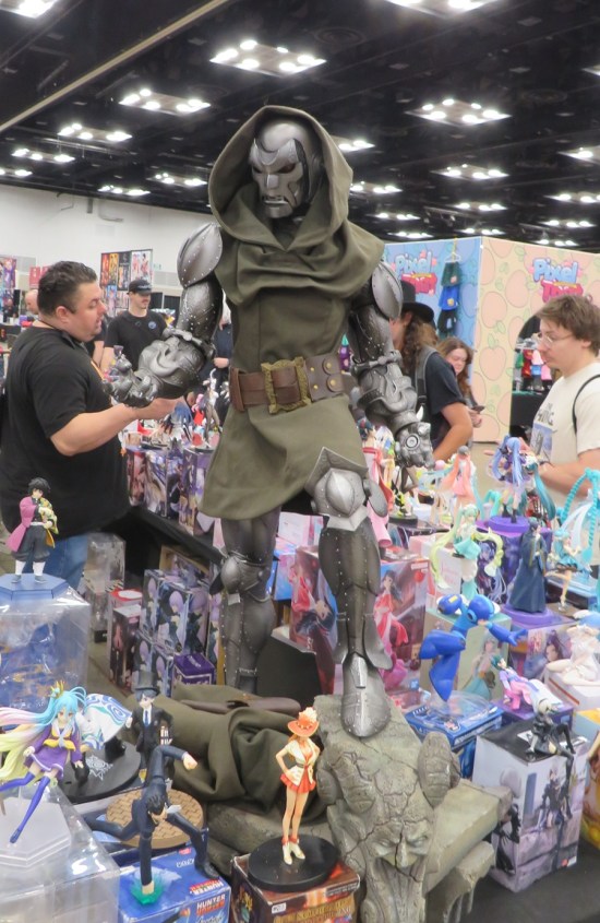 large Dr. Doom statue towers over other collectibles on a table.