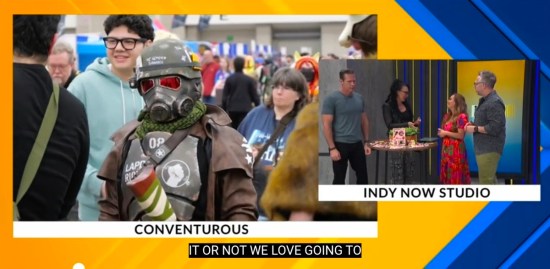Morning-news footage of us walking through a comic-con behind a video-game soldier. Caption reads "CONVENTUROUS"