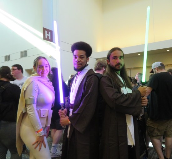 three Star Wars cosplayers, one Padme and two Jedi