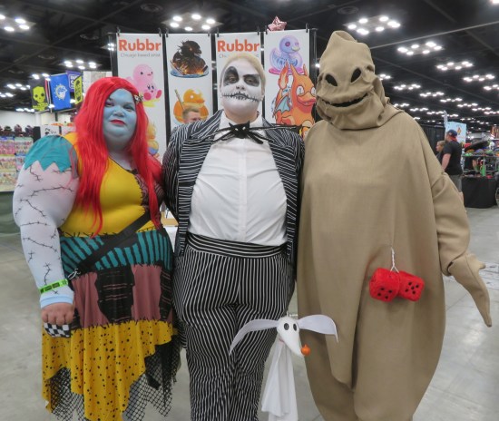 three cosplayers, refer to caption