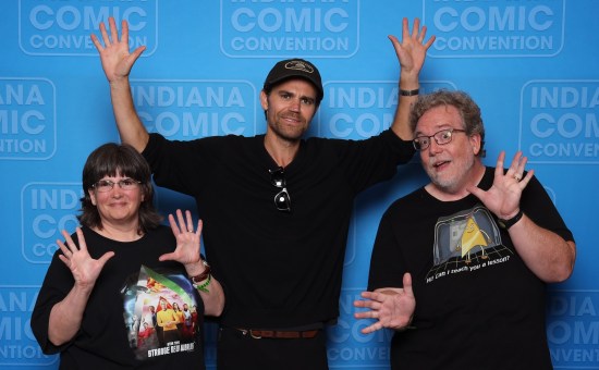 us doing jazz hands with Paul Wesley, who's wearing a black shirt and ball cap.