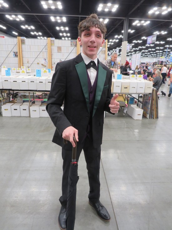 Young Penguin costume in tuxedo with cane.
