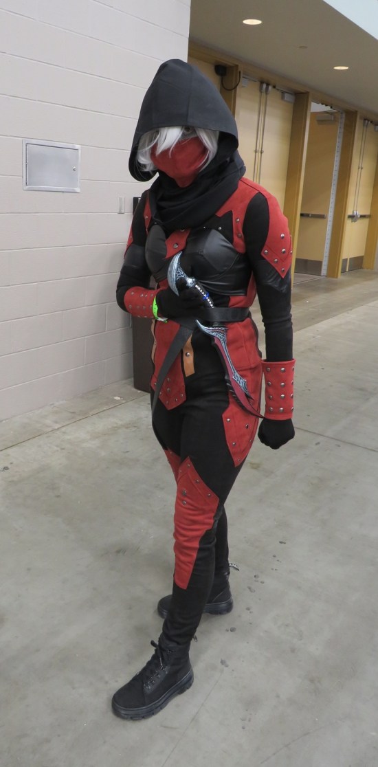 Red and black female assassin costume with wicked dagger