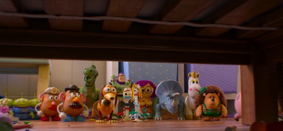 15 different plaything characters on a wooden floor, staring under the bed.