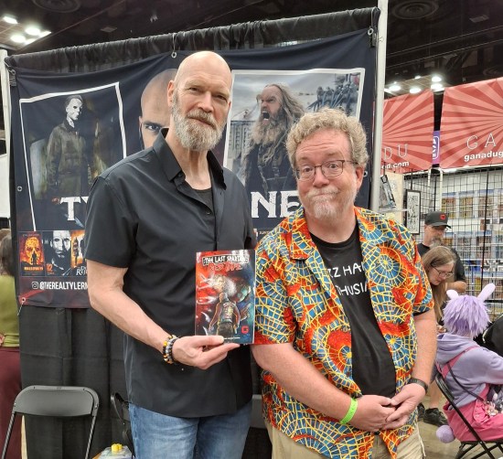 Me with Tyler Mane in his booth, holding up a copy of that graphic novel.
