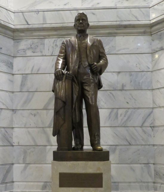 Alben Barkley statue, leaning on a post with his coat draped on it.