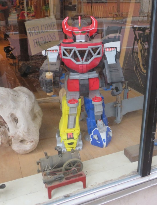 Mighty Morphin Power Rangers Morphing Megazord toy in an antique store's front window.
