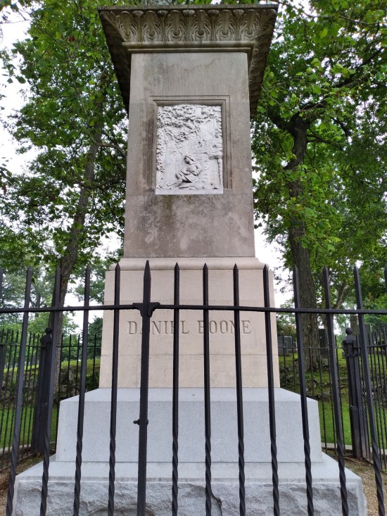 Daniel Boone grave viewed through a midsize iron fence.
