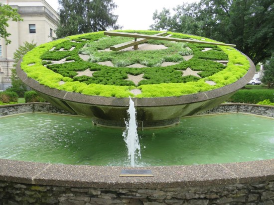 Giant clock made of greenery.
