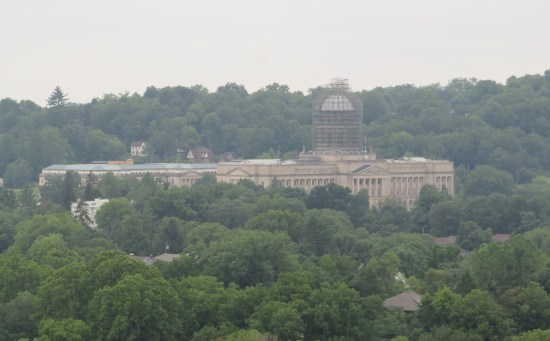 Zoomed shot of the Kentucky State Capitol amid all the trees, dome construction in progress.