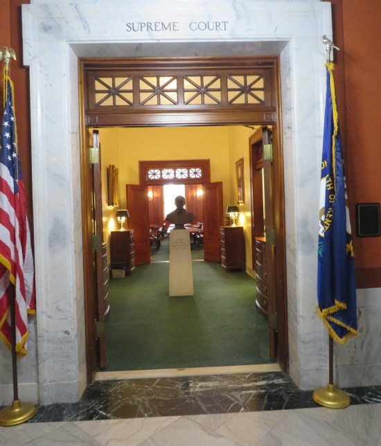 KY Supreme Court doorway with flags on either side and inside is someone's bust.