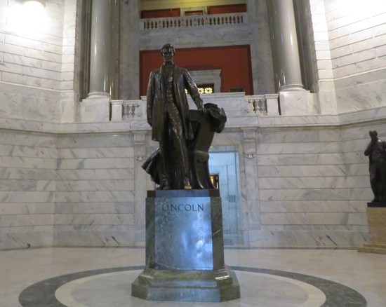 Lincoln statue in the center of a round room atop a pedestal engraved with "LINCOLN"