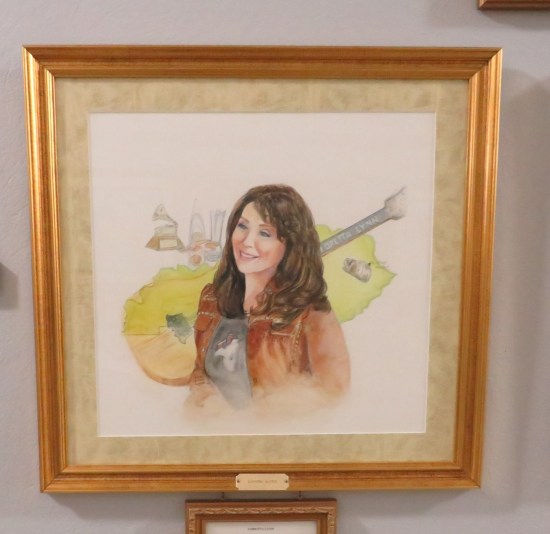 Loretta Lynn drawing, with a guitar floating behind her.