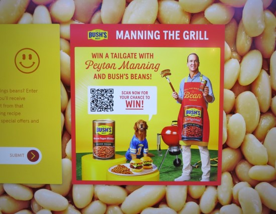 Baked bean welcome center wall art has a pic of Peyton Manning in a red apron doing a contest.