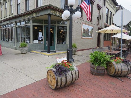 Serafini restaurant with tables and bourbon barrels on the surrounding sidewalks.