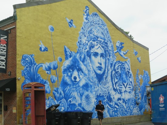 Yellow mural with blue and white ghosts, some of them animals.