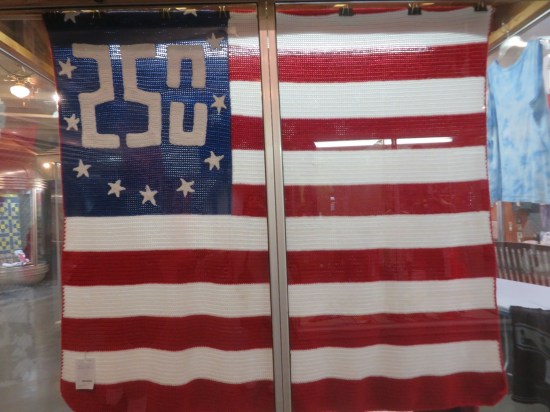 Blanket like a US flag but the 50 stars are replaced by the number 250 encircled by only about 14 or 15 stars.