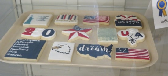 Twelve cookies decorated with various American symbols.